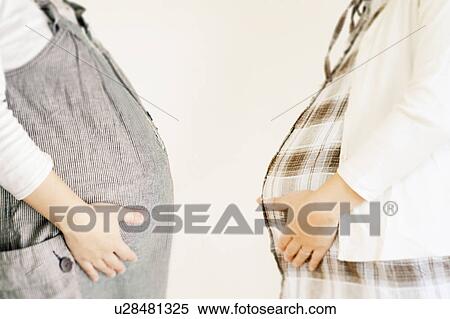 Stock Photography - Two Pregnant Women Standing Face to Face. Fotosearch