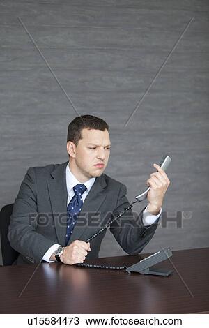 Unhappy Businessman at Desk View Large Photo Image Stock Image - Unhappy Businessman at Desk. Fotosearch