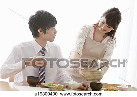 Woman Serving Food to Her Boyfriend View Large Photo Image Stock Image - Woman Serving Food to Her Boyfriend. Fotosearch