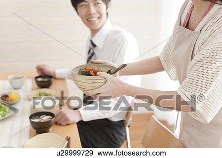 Stock Photo - Woman Serving Food to Her Boyfriend. Fotosearch