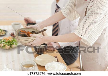 Woman Serving Food to Her Boyfriend View Large Photo Image Stock Photograph - Woman Serving Food to Her Boyfriend. Fotosearch