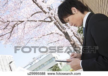 Stock Photo - Young Businessman Using Digital Tablet. Fotosearch