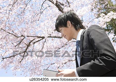 Stock Photography - Young Businessman Using Digital Tablet. Fotosearch