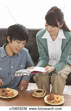 Young Couple Having Tea and Reading Book View Large Photo Image Stock Photo - Young Couple Having Tea and Reading Book. Fotosearch