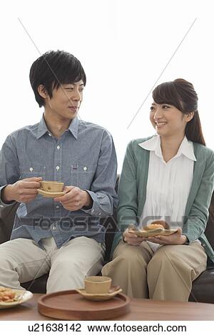 Stock Image - Young Couple Having Tea and Snack. Fotosearch