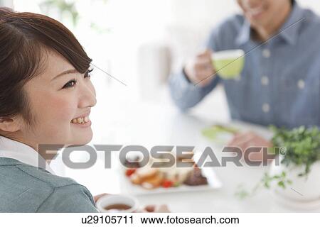 Stock Image - Young Couple Having Tea and Snack. Fotosearch