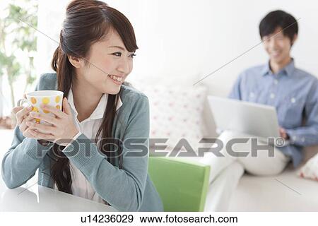 Stock Photo - Young Couple Relaxing at Home. Fotosearch