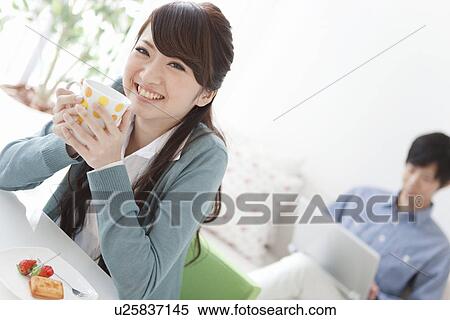 Stock Photography - Young Couple Relaxing at Home. Fotosearch