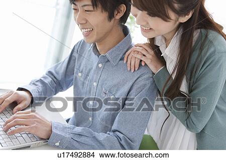 Young Couple Using Laptop View Large Photo Image Picture - Young Couple Using Laptop. Fotosearch