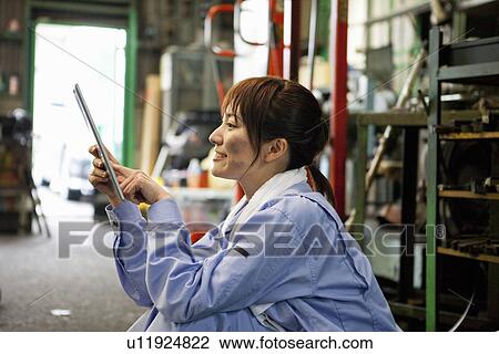 Young Female Worker Using Digital Tablet View Large Photo Image Stock Image - Young Female Worker Using Digital Tablet. Fotosearch