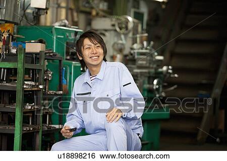 Young Male Factory Worker Sitting By Tools View Large Photo Image Stock Photograph - Young Male Factory Worker Sitting By Tools. Fotosearch