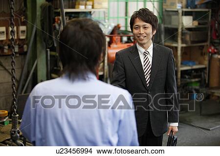 Picture - Young Male Worker Shaking Boss'S Hand. Fotosearch