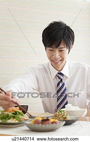 Young Man Eating Breakfast View Large Photo Image Picture - Young Man Eating Breakfast. Fotosearch
