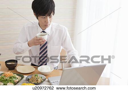 Young Man Having Breakfast and Using Laptop View Large Photo Image Stock Image - Young Man Having Breakfast and Using Laptop. Fotosearch
