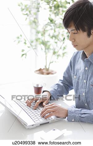 Young Man Using Laptop View Large Photo Image Stock Photo - Young Man Using Laptop. Fotosearch