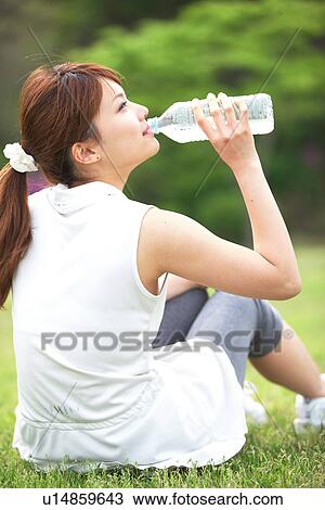 Young Woman Drinking Water From Plastic Water Bottle View Large Photo Image Stock Image - Young Woman Drinking Water From Plastic Water Bottle. Fotosearch