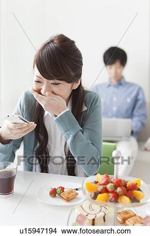 Young Woman Giggling at Text Message View Large Photo Image Picture - Young Woman Giggling at Text Message. Fotosearch