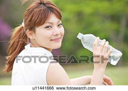 Young Woman Holding Plastic Water Bottle View Large Photo Image Stock Photograph - Young Woman Holding Plastic Water Bottle. Fotosearch