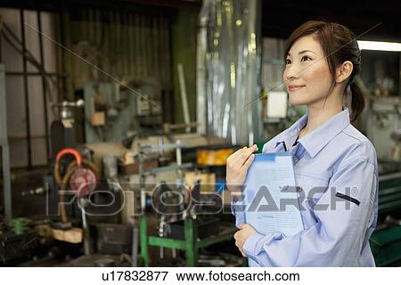 Stock Photo - Young Woman In Factory. Fotosearch