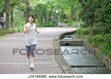 Young Woman Jogging Along Riverside in Spring View Large Photo Image Stock Image - Young Woman Jogging Along Riverside in Spring. Fotosearch