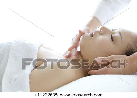 Young Woman Receiving Facial Massage, Head And Shoulders View Large Photo Image Stock Photography - Young Woman Receiving Facial Massage, Head And Shoulders. Fotosearch