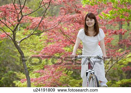 Young Woman Riding On Bicycle In Fall Forest View Large Photo Image Stock Photo - Young Woman Riding On Bicycle In Fall Forest. Fotosearch