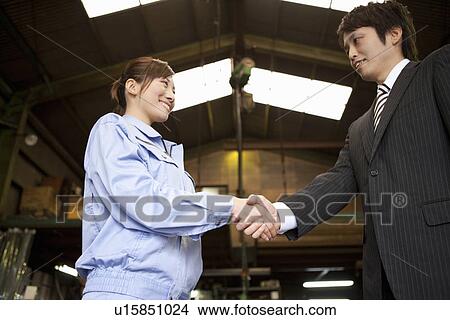 Picture - Young Woman Shaking Boss'S Hand. Fotosearch
