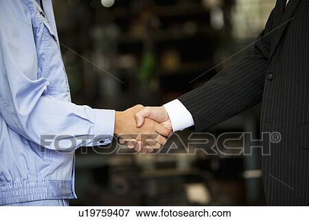 Stock Photo - Young Woman Shaking Boss'S Hand. Fotosearch