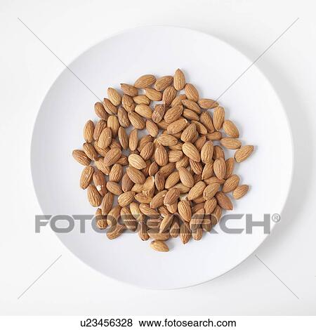 Stock Photo - Almonds on plate, studio shot. Fotosearch