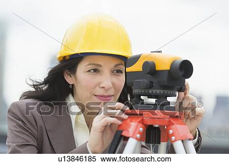 Stock Photography - Architect looking through theodolite. Fotosearch