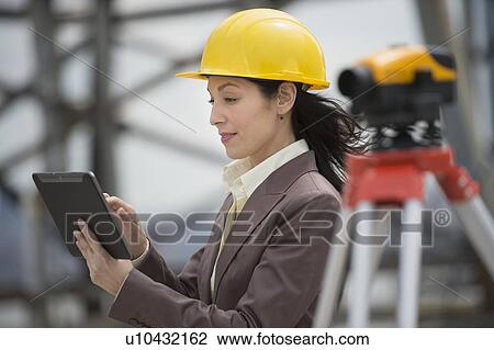 Architect using digital tablet in construction site View Large Photo Image Stock Image - Architect using digital tablet in construction site. Fotosearch
