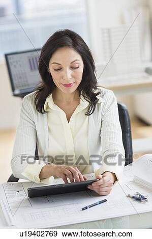 Architect working on digital tablet in office View Large Photo Image Stock Photo - Architect working on digital tablet in office. Fotosearch