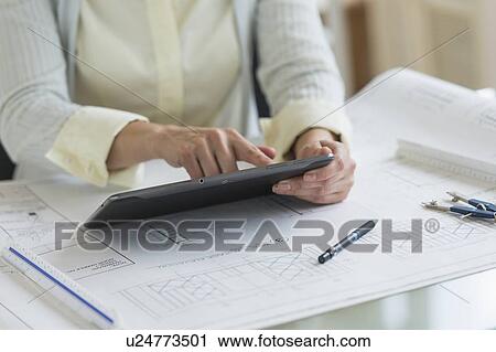 Architect working on digital tablet View Large Photo Image Stock Image - Architect working on digital tablet. Fotosearch