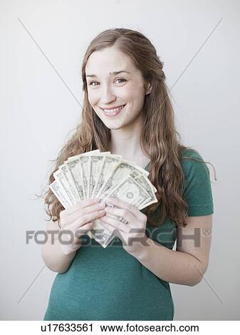 Attractive young woman holding fan made up from us dollar banknotes View Large Photo Image Stock Image - Attractive young woman holding fan made up from us dollar banknotes. Fotosearch