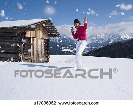 Austria, Maria Alm, Woman at top of mountain enjoying snowball fight View Large Photo Image Stock Image - Austria, Maria Alm, Woman at top of mountain enjoying snowball fight. Fotosearch