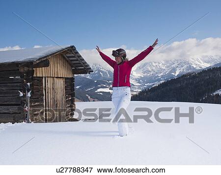 Stock Photo - Austria, Maria Alm, Woman at top of mountain spreading arms. Fotosearch