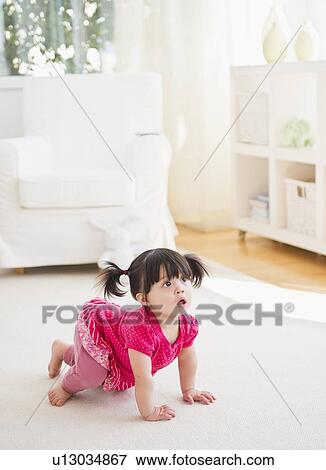 Baby girl (12-17 months) crawling on carpet View Large Photo Image Stock Photo - Baby girl (12-17 months) crawling on carpet. Fotosearch