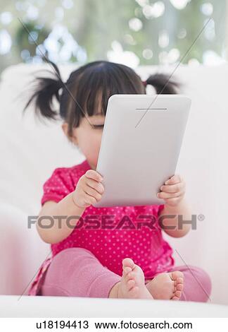 Baby girl (12-17 months) playing with digital tablet View Large Photo Image Stock Image - Baby girl (12-17 months) playing with digital tablet. Fotosearch