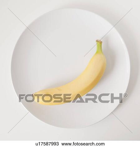 Stock Image - Banana on plate, studio shot. Fotosearch