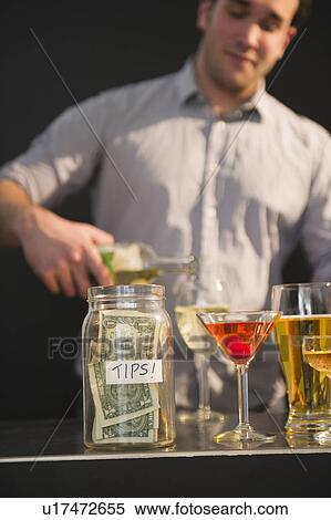 Stock Photography - Bar tender pouring wine into glass. Fotosearch