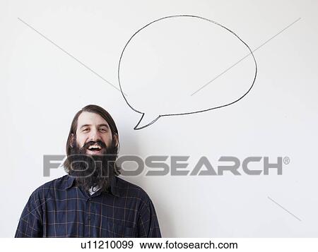 Bearded young man standing next to speech bubble on white background View Large Photo Image Stock Photo - Bearded young man standing next to speech bubble on white background. Fotosearch