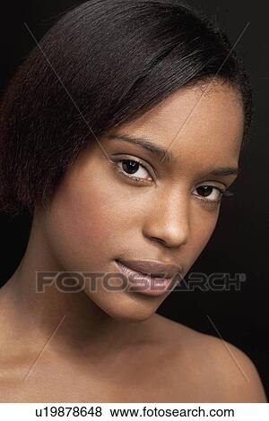 Beautiful young woman looking at camera View Large Photo Image Stock Photo - Beautiful young woman looking at camera. Fotosearch