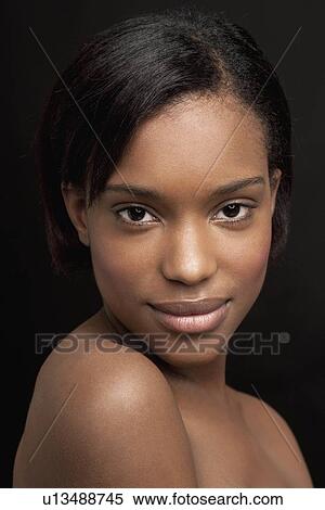 Stock Photography - Beautiful young woman looking at camera. Fotosearch