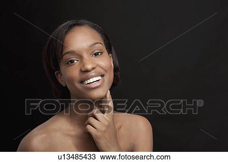 Beautiful young woman smiling and looking at camera View Large Photo Image Stock Image - Beautiful young woman smiling and looking at camera. Fotosearch