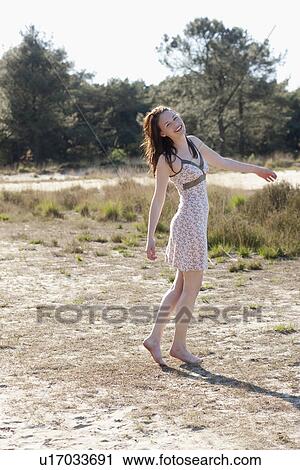 Belgium, Kalmthoutse Heide, Young woman walking barefoot View Large Photo Image Stock Image - Belgium, Kalmthoutse Heide, Young woman walking barefoot. Fotosearch