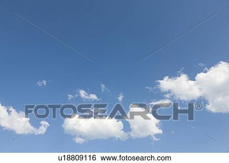Blue sky with puffy clouds View Large Photo Image Stock Photograph - Blue sky with puffy clouds. Fotosearch