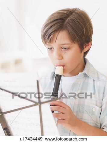 Boy (10-11 years) playing flute View Large Photo Image Stock Photo - Boy (10-11 years) playing flute. Fotosearch