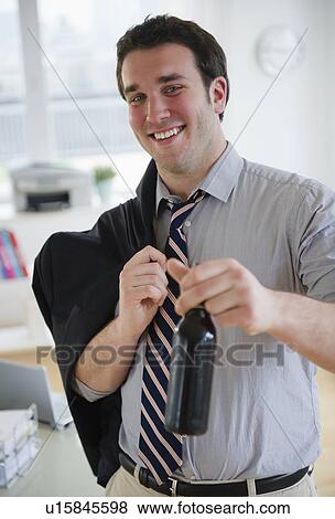 Business man leaving office with beer bottle View Large Photo Image Stock Photo - Business man leaving office with beer bottle. Fotosearch