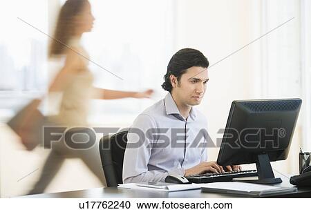Stock Image - Business man working in office. Fotosearch