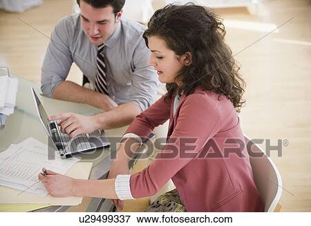 Stock Photo - Business people working in office. Fotosearch